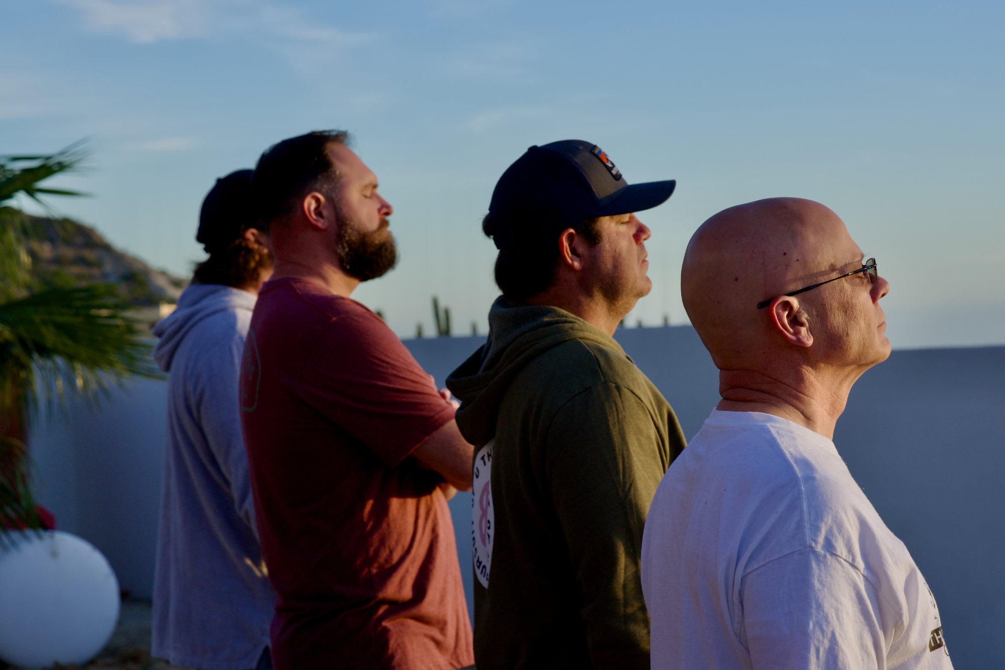 Men watching sunrise together