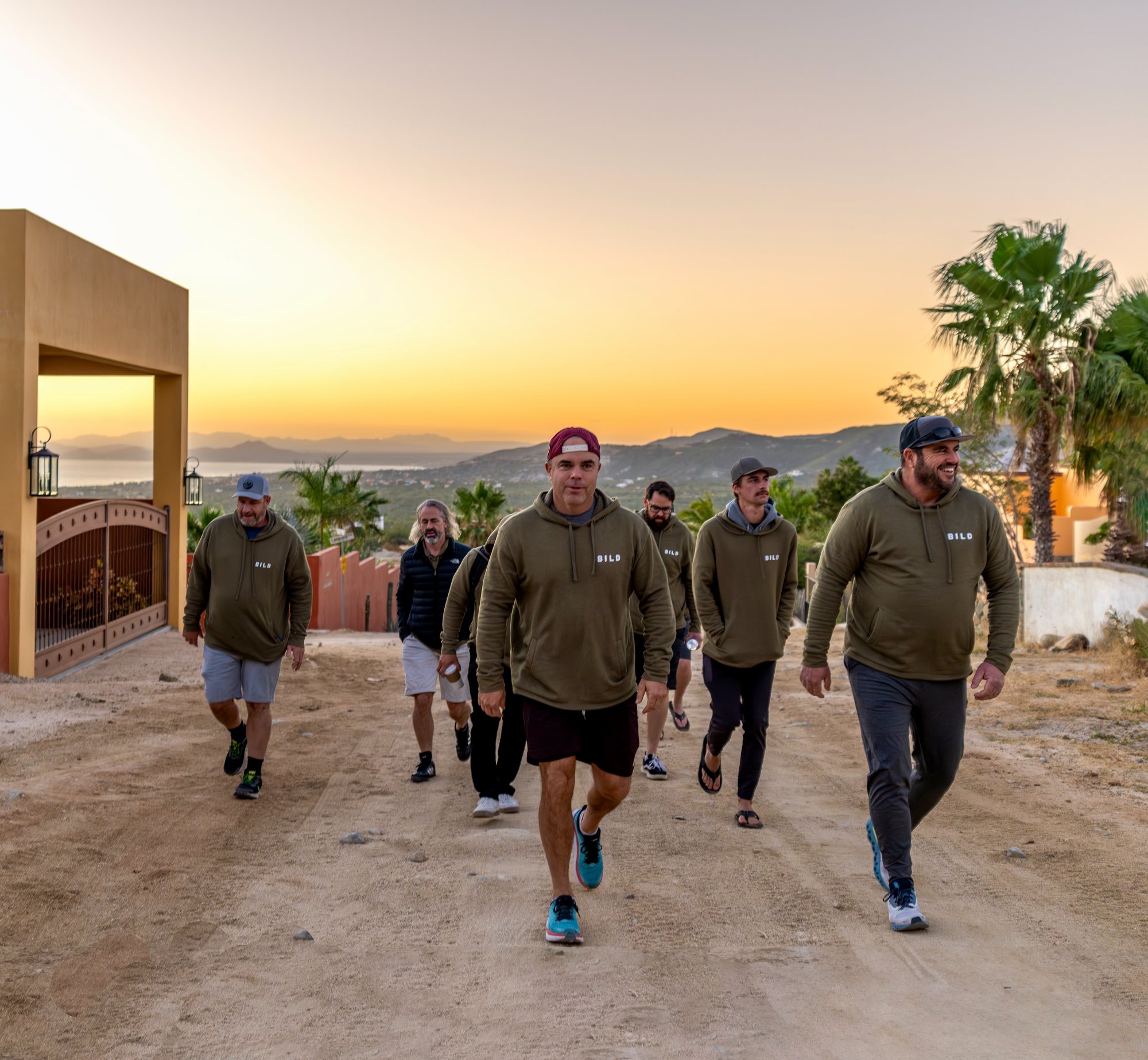 Men walking at sunrise