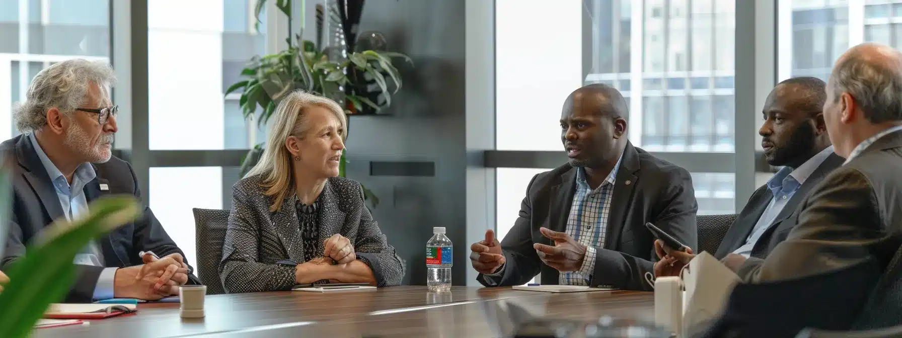 a diverse group of business owners discussing insurance and protection strategies in a conference room.